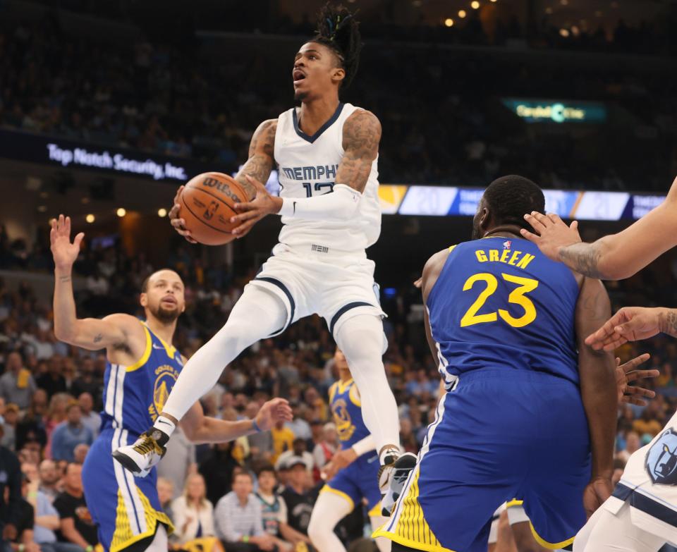 May 1, 2022; Memphis, Tennessee, USA; Memphis Grizzlies guard Ja Morant (12) attempts a layup against the Golden State Warriors during game one of the second round for the 2022 NBA playoffs at FedExForum. Mandatory Credit: Joe Rondone-USA TODAY Sports