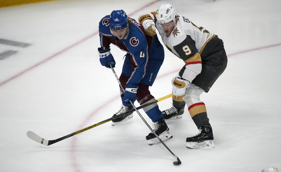 Colorado Avalanche defenseman Bowen Byram, left, shoots as Vegas Golden Knights center Jack Eichel defends in the first period of an NHL hockey game Monday, Feb. 27, 2023, in Denver. (AP Photo/David Zalubowski)