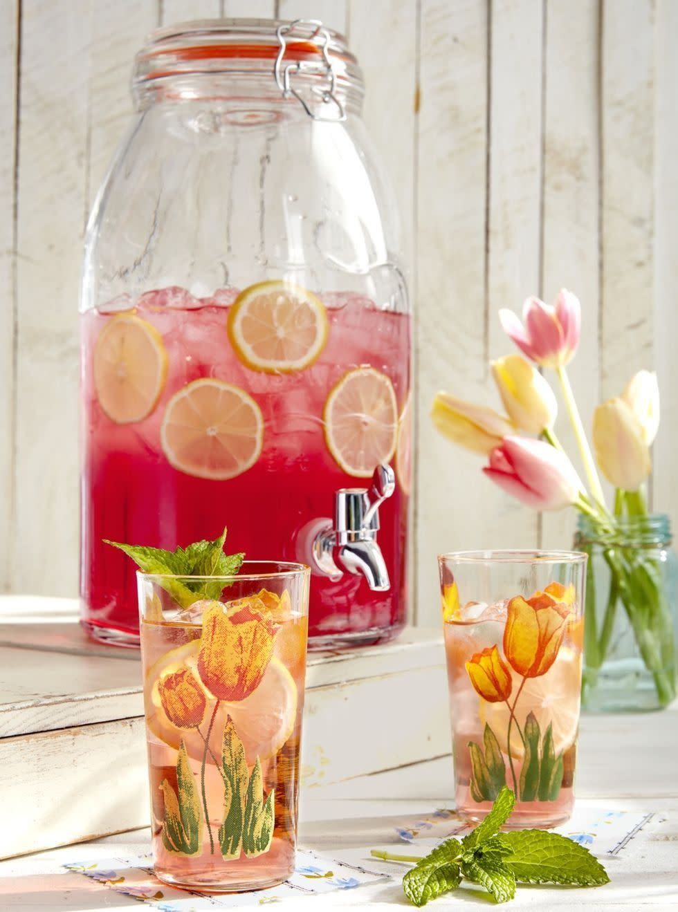 mint tulip cocktail in glasses with ice and slices of lemon and fresh mint