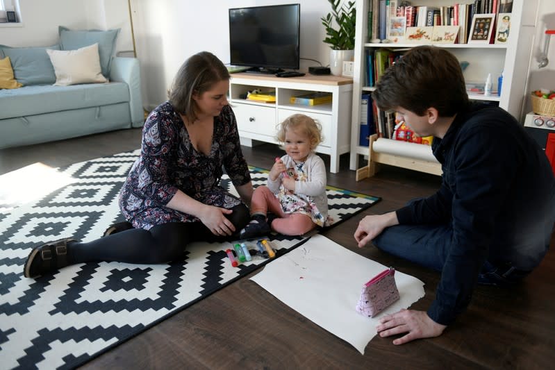 FILE PHOTO: Scharle and her husband play with their daughter in Budakeszi, a western suburb of Budapest