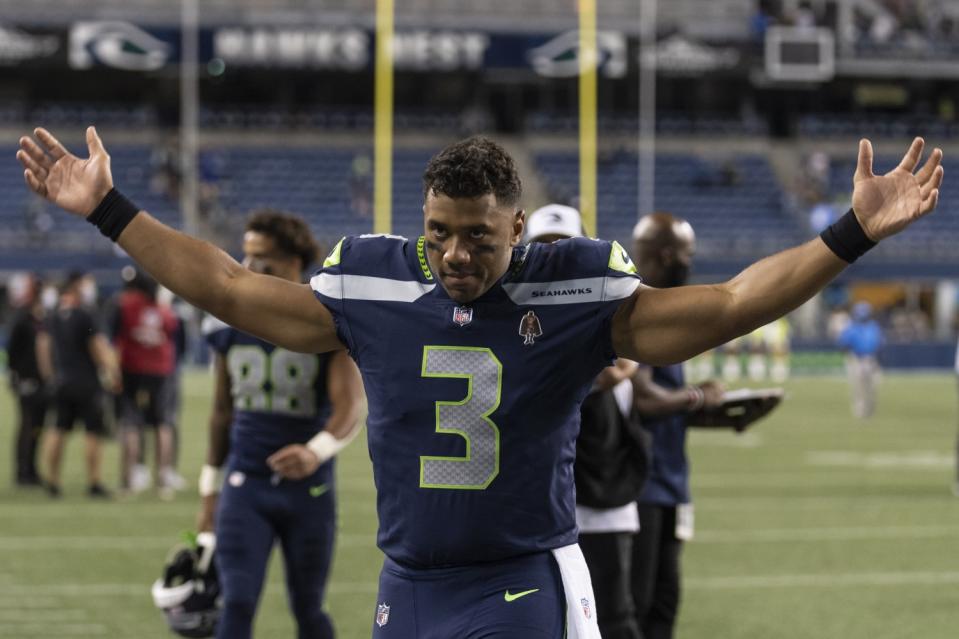 Seattle Seahawks quarterback Russell Wilson gestures as he walks off the field.