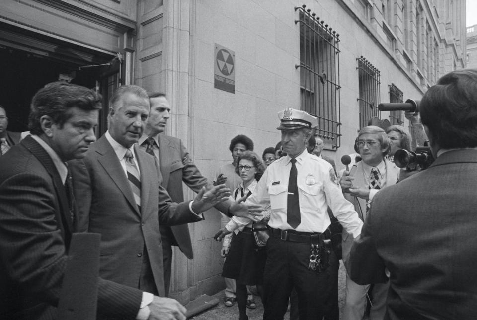Spiro Agnew leaves a Baltimore federal courthouse on Oct. 10, 1973, after pleading no contest to tax evasion charges and resigning as vice president. <a href="https://www.gettyimages.com/detail/news-photo/spiro-agnew-flanked-by-secret-service-agents-leaves-federal-news-photo/515575060?adppopup=true" rel="nofollow noopener" target="_blank" data-ylk="slk:Bettmann via Getty Images;elm:context_link;itc:0;sec:content-canvas" class="link ">Bettmann via Getty Images</a>