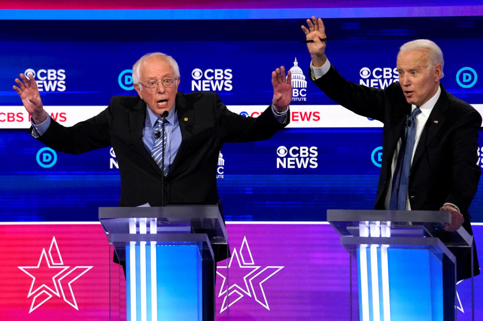 Democratic 2020 U.S. presidential candidates Senator Bernie Sanders and former Vice President Joe Biden talk at the tenth Democratic 2020 presidential debate at the Gaillard Center in Charleston, South Carolina, U.S. February 25, 2020. REUTERS/Jonathan Ernst