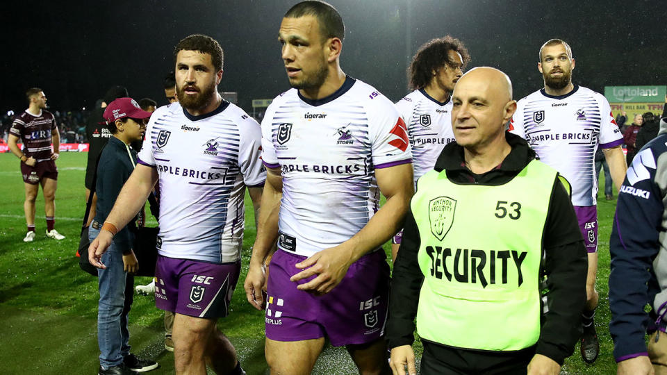 Will Chambers, pictured here being escorted from the field by security.