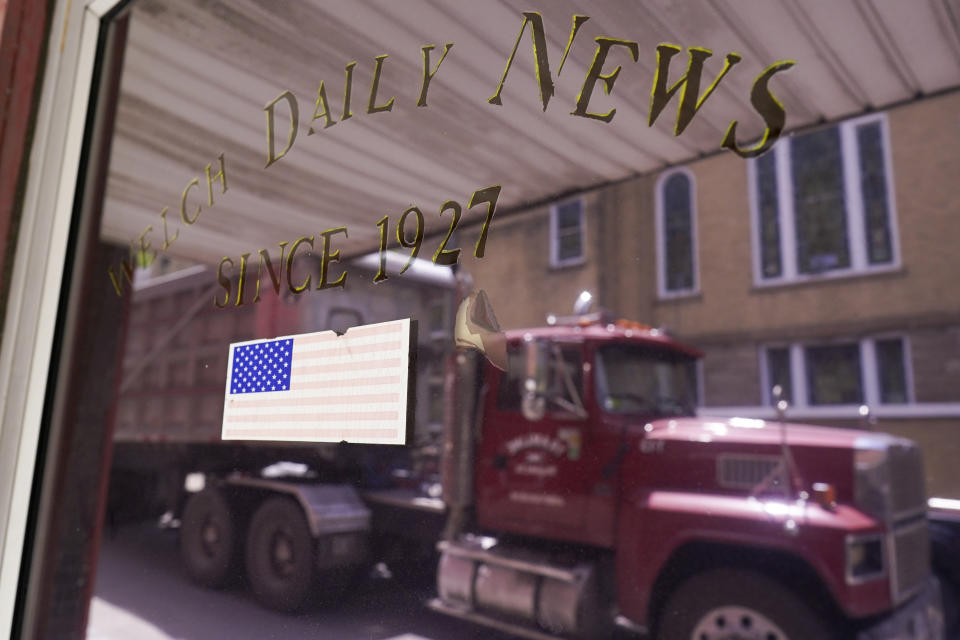 A truck drives past the now closed office of the The Welch News on Wednesday, May 31, 2023, in Welch, W.Va. In March, the weekly publication in McDowell County one of the poorest counties America became another one of the quarter of all U.S. newspapers that have shuttered since 2005, a crisis Nester called "terrifying for democracy" and one that disproportionately impacts rural America. (AP Photo/Chris Carlson)