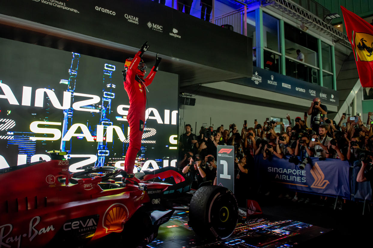 Ferrari driver Carlos Sainz celebrates winning the 2023 F1 Singapore Grand Prix at the Marina Bay street circuit.
