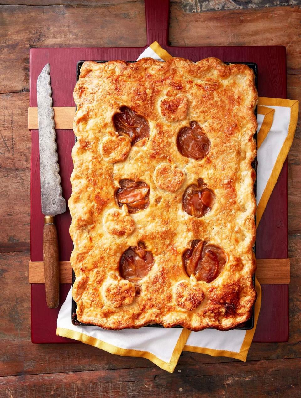 salted caramel apple slab pie on a cutting board with a vintage knife