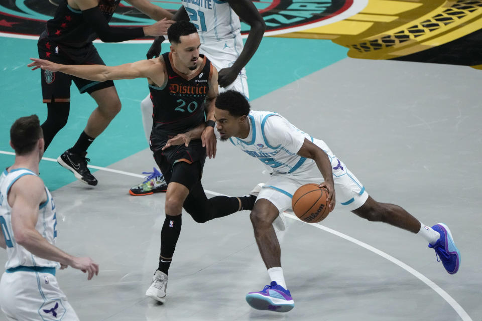 Charlotte Hornets guard Theo Maledon (9) drives against Washington Wizards guard Landry Shamet (20) during the first half of an NBA basketball game Friday, Nov. 10, 2023, in Washington. (AP Photo/Mark Schiefelbein)
