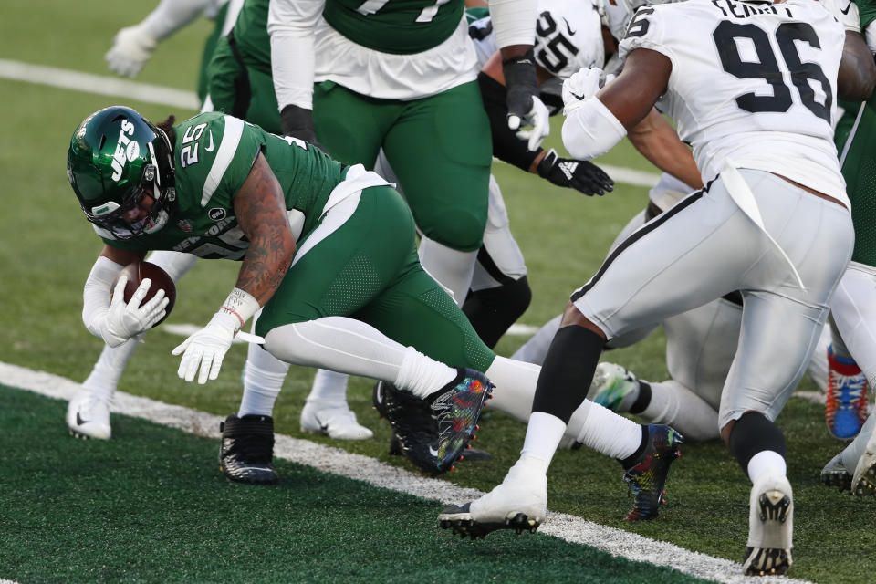 New York Jets' Ty Johnson, left, scores a touchdown during the second half an NFL football game against the Las Vegas Raiders, Sunday, Dec. 6, 2020, in East Rutherford, N.J. (AP Photo/Noah K. Murray)