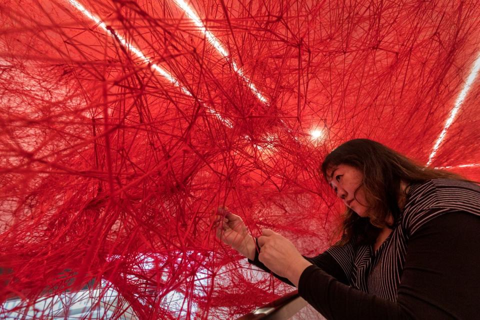 Artist Chiharu Shiota working on her installation, "The Network."