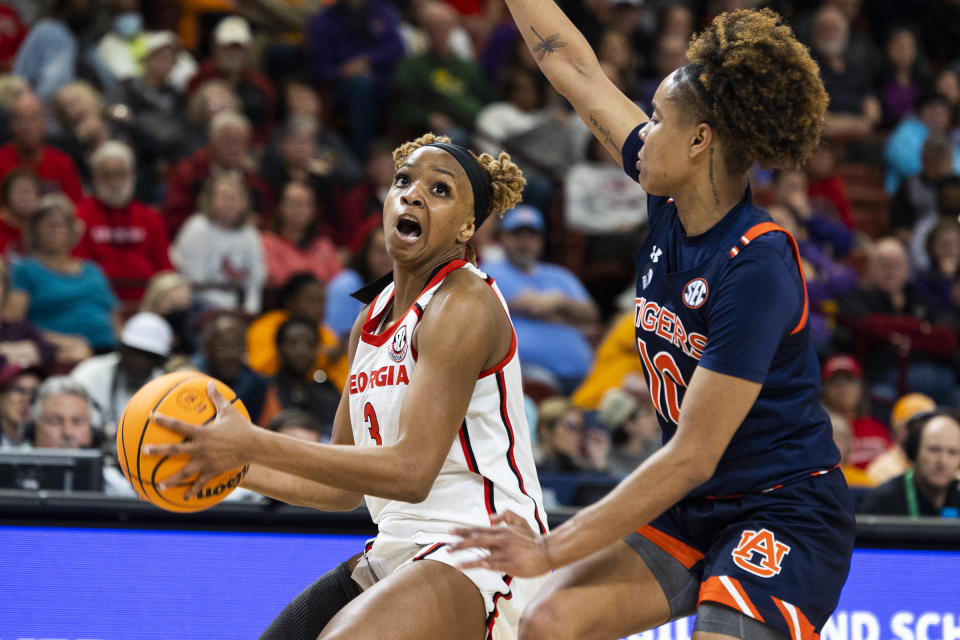 Georgia's Diamond Battles (3) goes in for a layup against Auburn's Sydney Shaw (10) during the first half of an NCAA college basketball game in the Southeastern Conference women's tournament in Greenville, S.C., Thursday, March 2, 2023. (AP Photo/Mic Smith)