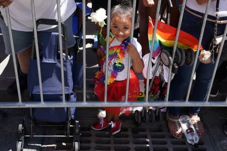 A child watches as participants take part in the LGBT Pride March in the Manhattan borough of New York City, U.S., June 25, 2017. REUTERS/Carlo Allegri