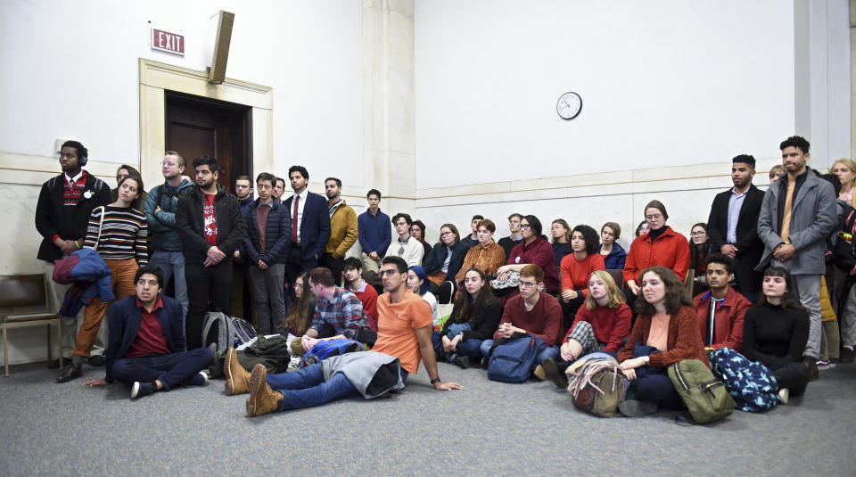 Students from Yale and Harvard University along with members of the Greater New Haven community charged with disorderly conduct after a protest interrupted the annual Yale Harvard football game, wait in Superior Court in New Haven, Connecticut, for their arraignments on Friday, Dec. 6, 2019. (Arnold Gold/New Haven Register via AP, Pool)