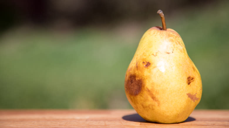 Bruised pear on table