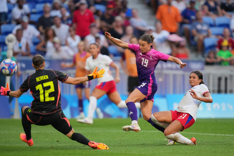 LYON, FRANCE - AUGUST 06: Sophia Smith #11 of the United States beats #12 Ann-Katrin Berger and #19 Felicitas Rauch of Germany to score during extra time of the women's semi-final during the Paris 2024 Olympic Games at the Stade de Lyon in 06 August 2024 in Lyon, France.  (Photo by John Todd/ISI/Getty Images)