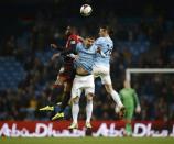 Manchester City's Martin Demichelis (R) and Aleksandar Kolarov (C) challenge West Bromwich Albion's Victor Anichebe during their English Premier League soccer match at the Etihad stadium in Manchester, northern England April 21, 2014. REUTERS/Nigel Roddis