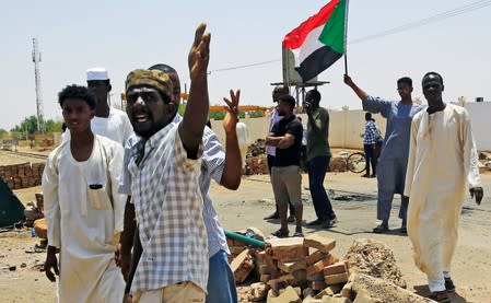 Sudanese protesters set up a barricade on a street, demanding that the country's Transitional Military Council hand over power to civilians, in Khartoum