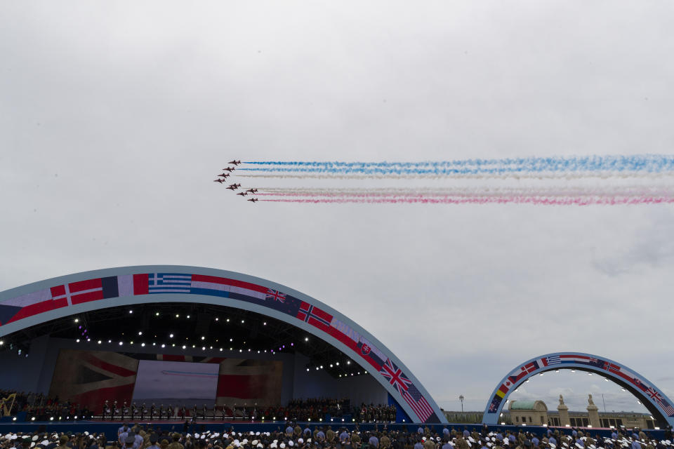 A flyover trails colored smoke to conclude a ceremony to mark the 75th Anniversary of D-Day, when the Allied soldiers, sailors and airmen conducted an invasion that helped liberate Europe from Nazi Germany, Wednesday, June 5, 2019, in Portsmouth, England. (AP Photo/Alex Brandon)