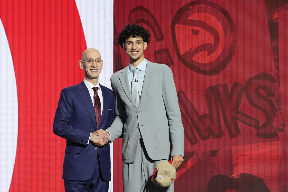 Zaccharie Risacher, right, poses for a photo with NBA commissioner Adam Silver after being selected as the first overall pick by the Atlanta Hawks in the first round of the NBA basketball draft, Wednesday, June 26, 2024, in New York. (AP Photo/Julia Nikhinson)