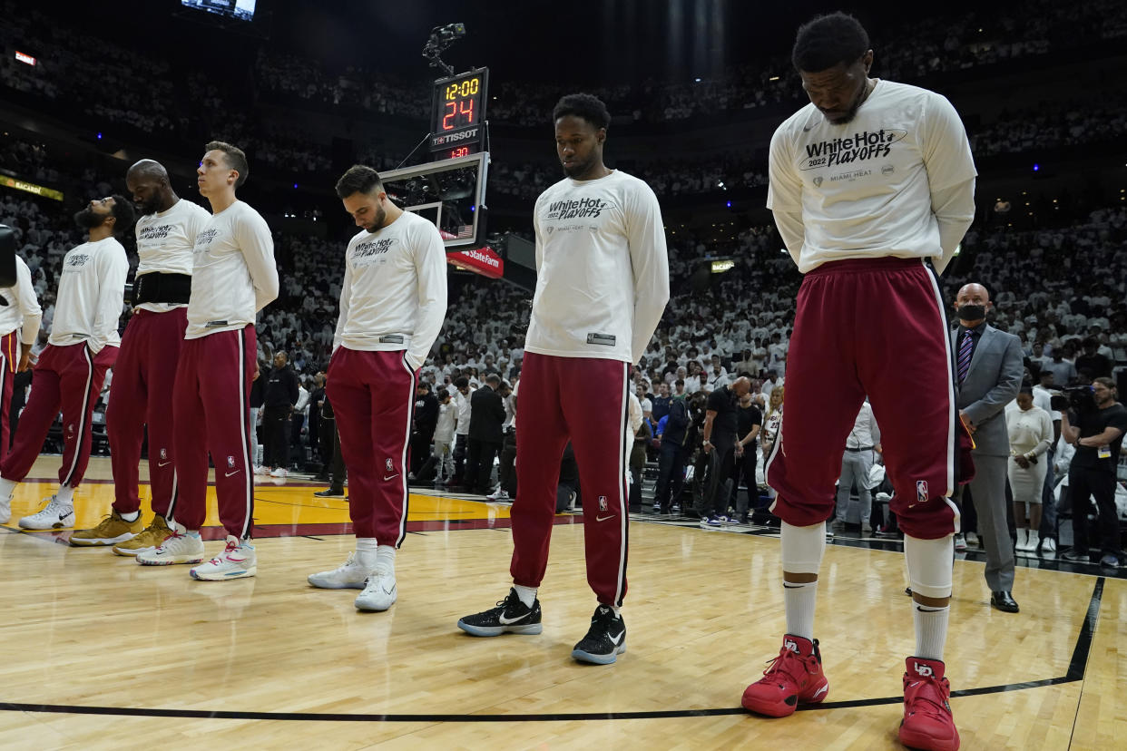 Miami Heat players pause for a moment of silence for those killed at the Robb Elementary School massacre in Uvalde, Texas, before the start of Game 5 of the Eastern Conference finals against the Boston Celtics on May 25, 2022, in Miami. (AP Photo/Lynne Sladky)