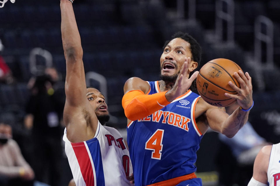 New York Knicks guard Derrick Rose (4) attempts a layup as Detroit Pistons guard Dennis Smith Jr. (0) defends during the first half of an NBA basketball game, Sunday, Feb. 28, 2021, in Detroit. (AP Photo/Carlos Osorio)