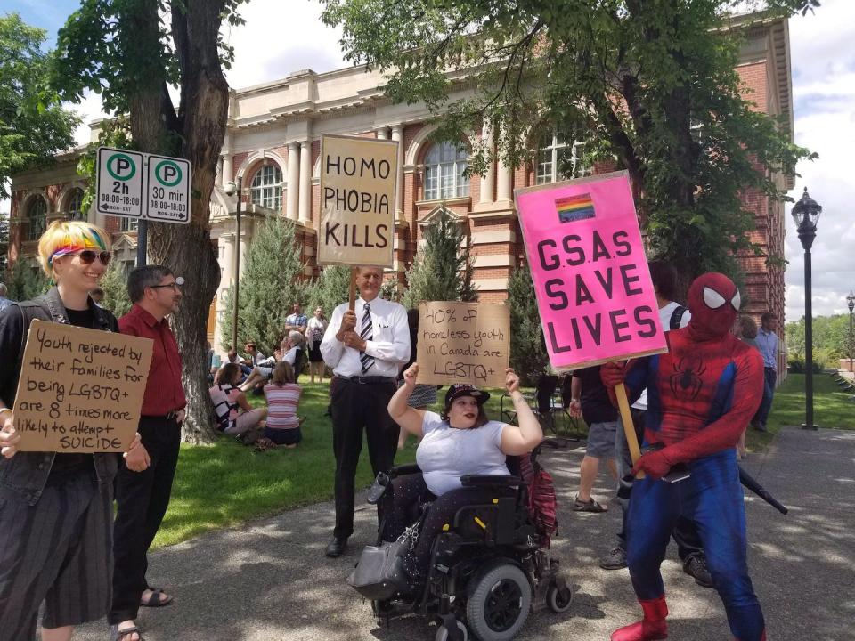 Protesters hold signs outside a courthouse in Medicine Hat, Alta. in June 2018 before a court challenge to an Alberta law that prevented schools from telling parents if their children joined gay-straight alliances. THE CANADIAN PRESS/Lauren Krugel