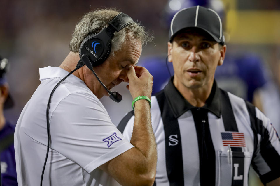 TCU coach Sonny Dykes, left, talks to an official during a timeout in the second half of the team's NCAA college football game against Nicholls State, Saturday, Sept. 9, 2023, in Fort Worth, Texas. (AP Photo/Gareth Patterson)