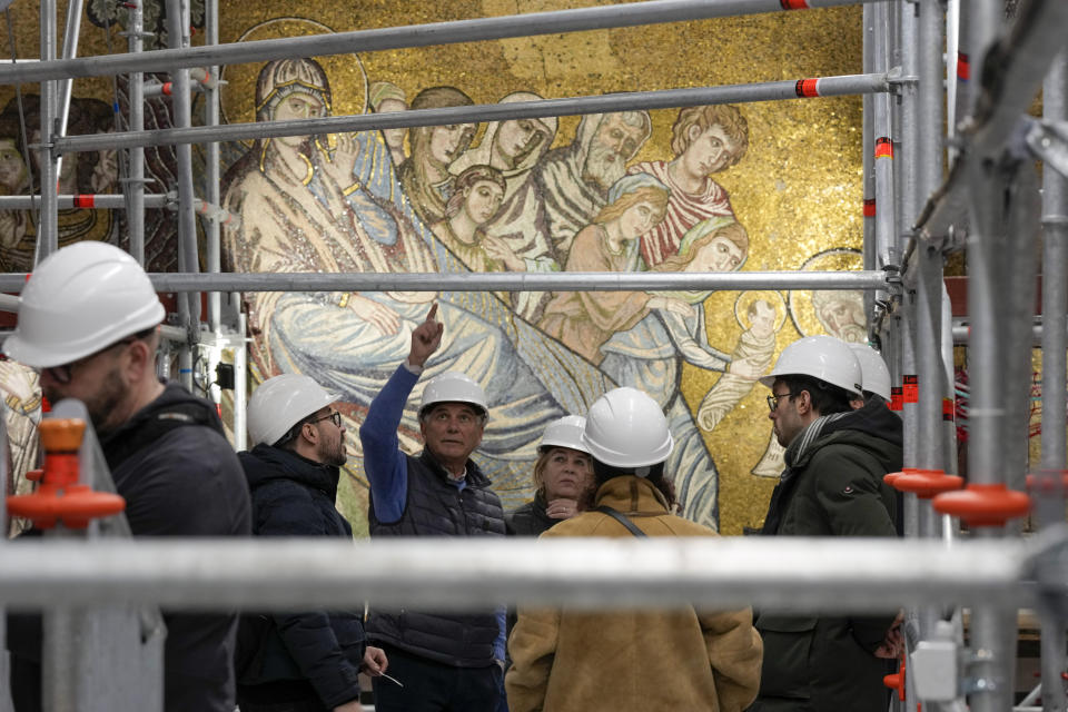 Technicians work at the restoration of the mosaics that adorn the dome of one of the oldest churches in Florence, St. John's Baptistery, in Florence, central Italy, Tuesday Feb. 7, 2023. The restoration work will be done from an innovative scaffolding shaped like a giant mushroom that will stand for the next six years in the center of the church, and that will be open to visitors allowing them for the first and perhaps only time, to come come face to face with more than 1,000 square meters of precious mosaics covering the dome. (AP Photo/Andrew Medichini)