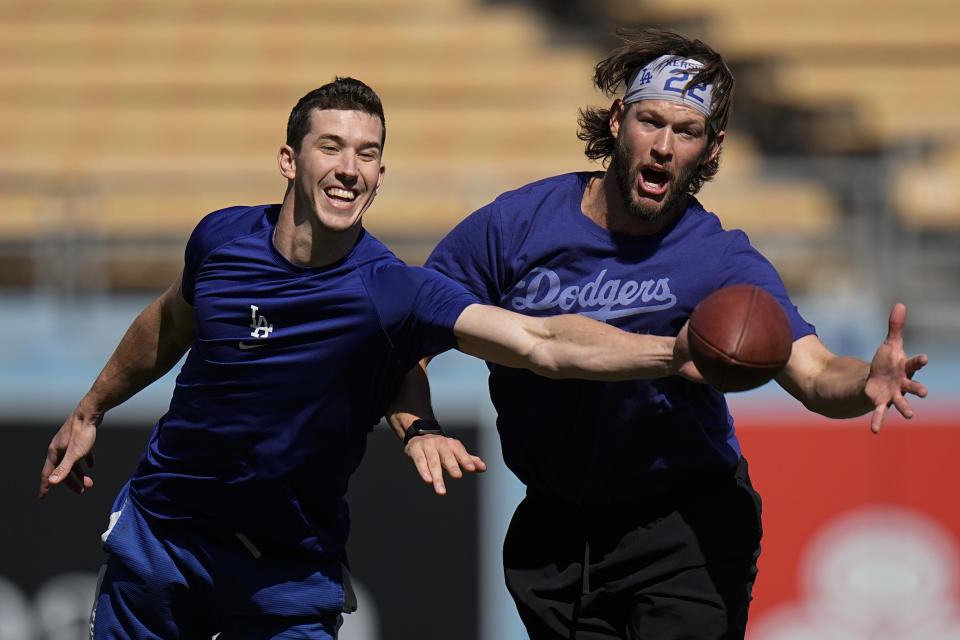 Los Angeles Dodgers' Walker Buehler, left and Clayton Kershaw play football before Game 4 of baseball's National League Championship Series between the Atlanta Braves and Los Angeles Dodgers, Wednesday, Oct. 20, 2021, in Los Angeles. (AP Photo/Jae Hong)