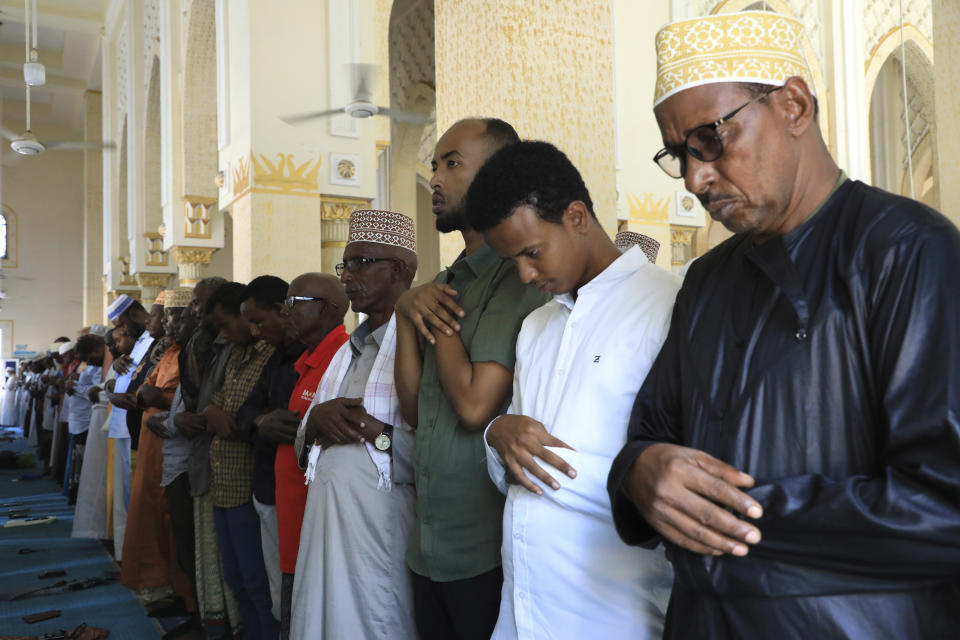 Somali men without facemasks pray at the Isbaheysiga Mosque in Mogadishu, Somalia on Friday Dec. 4, 2020. As richer countries race to distribute COVID-19 vaccines, Somalia remains the rare place where much of the population hasn't taken the coronavirus seriously. Some fear that’s proven to be deadlier than anyone knows. (AP Photo/Farah Abdi Warsameh)