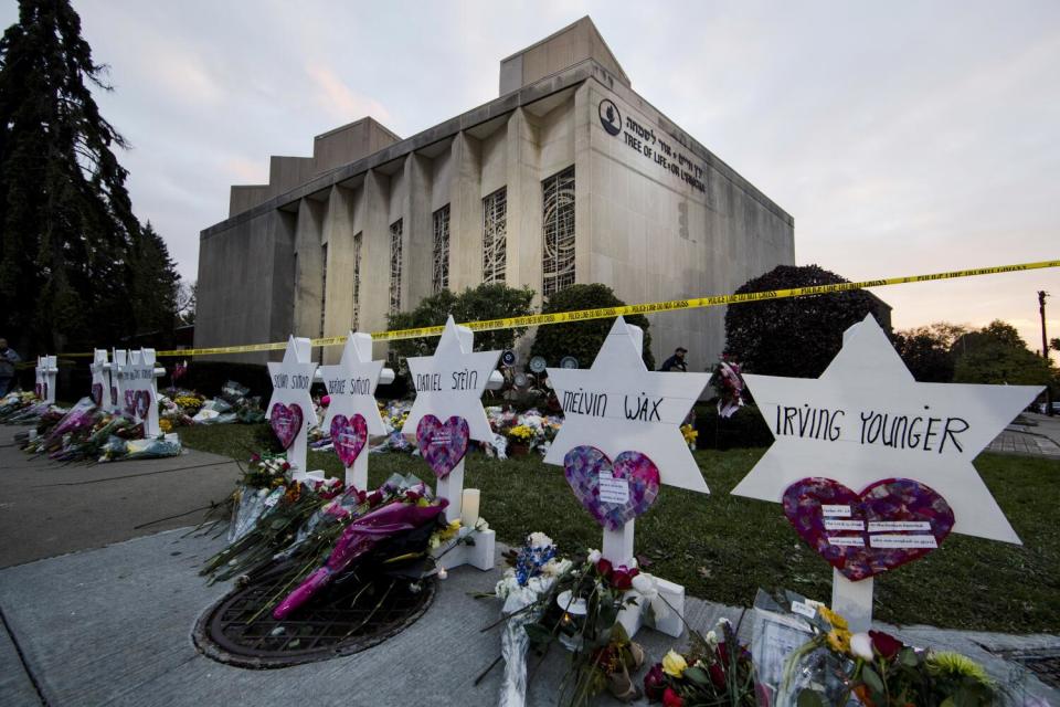 A memorial composed of Stars of David with names on them outside a synagogue