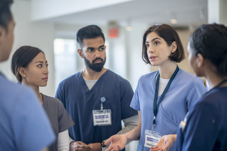 Group of healthcare professionals in discussion at a hospital