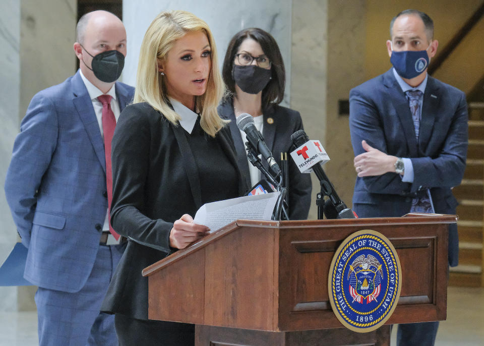 Paris Hilton, who has spoken out about the abuses she said she experienced at Provo Canyon School, center, was an advocate for the new law along with Utah Gov. Spencer Cox Cox and Lt. Gov. Deidre Henderson. Activists and supporters gathered in the Capitol rotunda in Salt Lake City, Tuesday, April 6, 2021, for a ceremonial bill signing of SB127 that will bring more oversight to the state's so-called troubled-teen industry. (Leah Hogsten/The Salt Lake Tribune via AP)