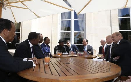 Nigerian President Goodluck Jonathan (5th L) attends the African Security Summit at the Elysee Palace in Paris in this May 17, 2014 file photo. From left: Cameroon's President Paul Biya, Benin's President Thomas Yayi Boni, Chad's President Idriss Deby, Niger's President Mahamadou Issoufou, Jonathan, an unidentified man, French President Francois Hollande, European Council President Herman Van Rompuy, Britain's Foreign Secretary William Hague and France's Defence Minister Jean-Yves Le Drian. REUTERS/Gonzalo Fuentes/Files