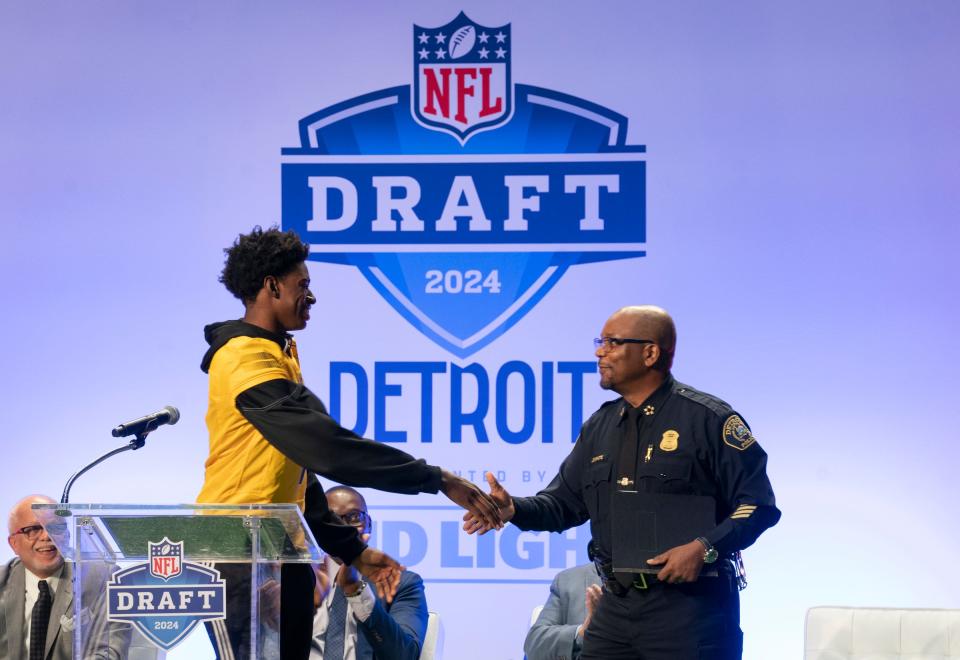 Detroit King's Wendell Brown Jr. left, introduces Detroit Police Chief James White as the Detroit Sports Commission and Visit Detroit mark 150 days until the 2024 NFL draft in Detroit in April, during a news conference at Ford Field on Monday, Nov. 27, 2023.