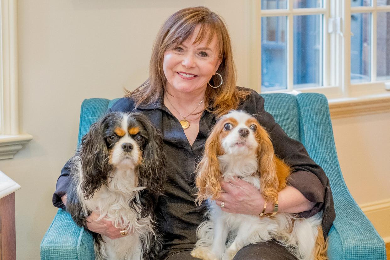 Brenda and her canine companions, Ollie and George, especially love the library and courtyard in their new home.