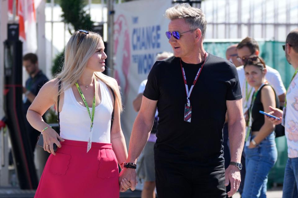 Gordon Ramsay walks with his daughter Tilly trough the paddock before the Italian Grand Prix race at the Monza racetrack, in Monza, Italy, Sunday, Sept. 11, 2022. (AP Photo/Luca Bruno)