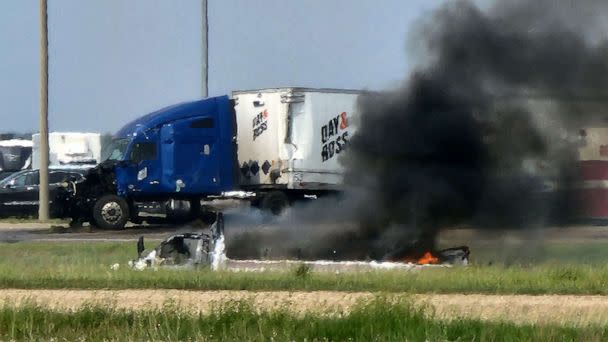 PHOTO: Smoke comes out of a car following a deadly accident near Carberry, west of Winnipeg, Canada, June 15, 2023. (Nirmesh Vadera/AFP via Getty Images)