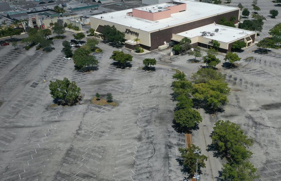 <span class="caption">In Plantation, Florida, an aerial view of a deserted Westfield Broward Mall, taken by a drone on May 5.</span> <span class="attribution"><a class="link " href="https://www.gettyimages.com/detail/news-photo/in-this-aerial-view-from-a-drone-an-empty-parking-lot-is-news-photo/1223091437?adppopup=true" rel="nofollow noopener" target="_blank" data-ylk="slk:Getty Images / Joe Raedle;elm:context_link;itc:0;sec:content-canvas">Getty Images / Joe Raedle</a></span>
