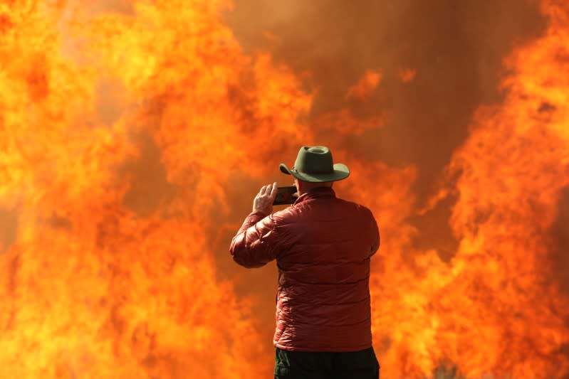 A wildfire dubbed the Cave Fire burns in the hills of Santa Barbara, California,