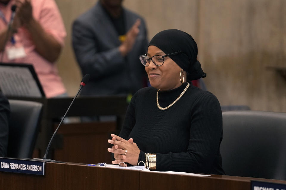 Boston City Councilor Tania Fernandes Anderson smiles following a vote, Wednesday, Oct. 25, 2023, at City Hall in Boston, in favor of holding a hearing on renaming Faneuil Hall. Fernandes Anderson has filed a resolution decrying the building's namesake, Peter Faneuil, as a "white supremacist, a slave trader, and a slave owner who contributed nothing recognizable to the ideal of democracy." (AP Photo/Steven Senne)