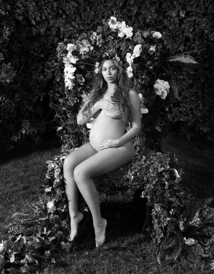 Beyoncé poses on a floral throne while wearing a flower crown (Photo: Beyonce.com)