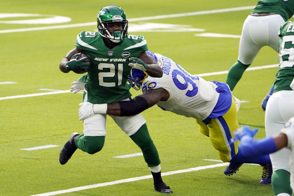 New York Jets running back Frank Gore (21) is tackled by Los Angeles Rams defensive end Michael Brockers (90) during the first half of an NFL football game Sunday, Dec. 20, 2020, in Inglewood, Calif. (AP Photo/Jae C. Hong)