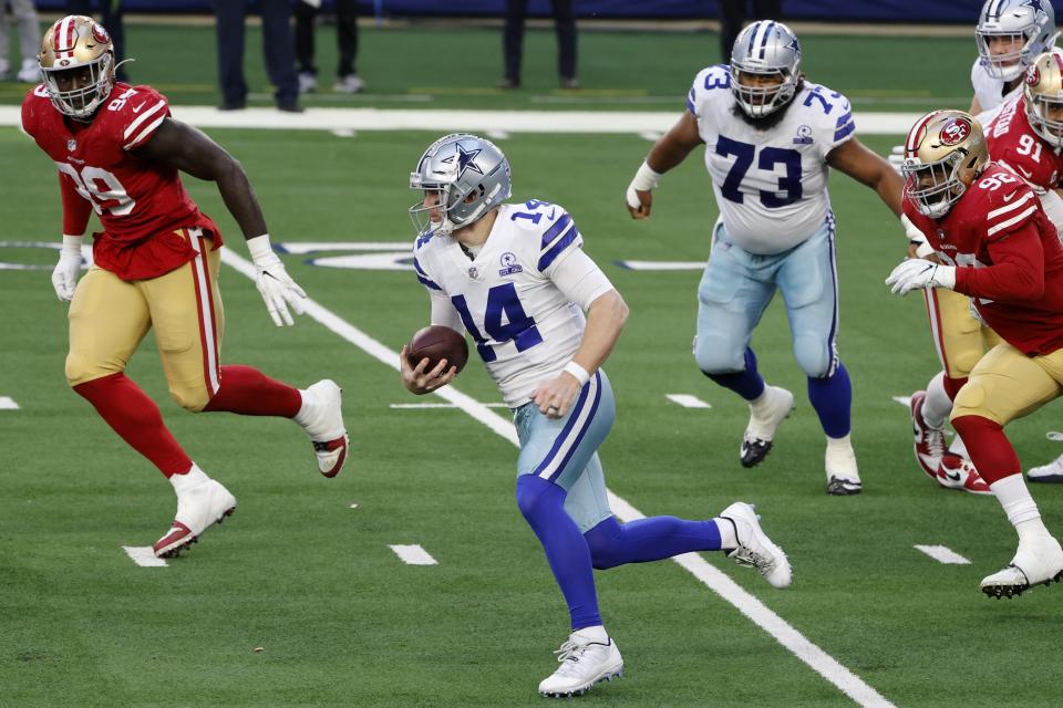 Dallas Cowboys quarterback Andy Dalton (14) keeps the ball for a gain of yardage as San Francisco 49ers defensive tackle Javon Kinlaw (99) and Kerry Hyder Jr. (92) give chase in the second half of an NFL football game in Arlington, Texas, Sunday, Dec. 20, 2020. (AP Photo/Michael Ainsworth)