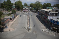 A road stands deserted during curfew in Srinagar, Indian controlled Kashmir, Tuesday, Aug. 4, 2020. Authorities clamped a curfew in many parts of Indian-controlled Kashmir on Tuesday, a day ahead of the first anniversary of India’s controversial decision to revoke the disputed region’s semi-autonomy. Shahid Iqbal Choudhary, a civil administrator, said the security lockdown was clamped in the region’s main city of Srinagar in view of information about protests planned by anti-India groups to mark Aug. 5 as “black day." (AP Photo/Mukhtar Khan)