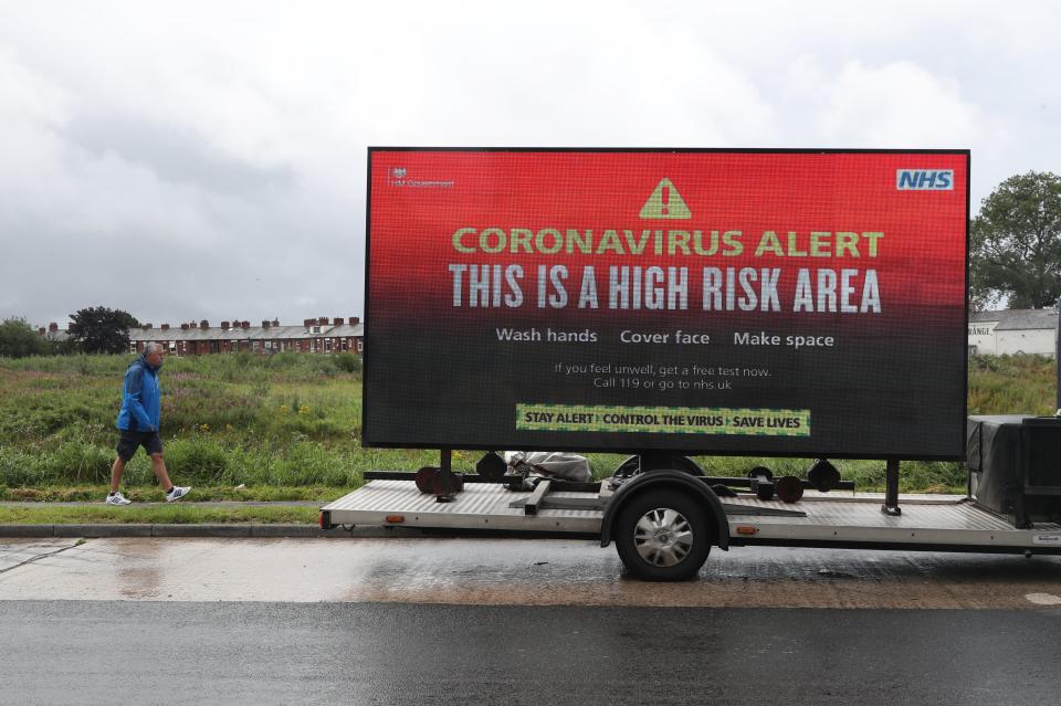 A mobile advertising vehicle displaying a coronavirus high risk area warning in Oldham, Greater ManchesterPA