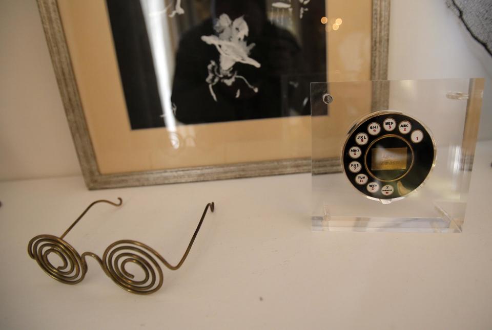 In this photo taken Wednesday, Oct. 17, 2012, the powder compact, right, designed by Dali for Elsa Schiaparelli and glasses designed by Man Ray are displayed at the Schiaparelli apartment in Paris. Inside the revamped apartments, Schiaparelli management has painstakingly recreated her surrealist universe. Original artifacts that artists designed for the Schiaparelli boutique are proudly on display. (AP Photo/Christophe Ena)