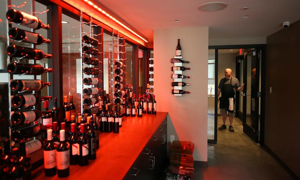 Crave owner/chef Aaron Hervey shows off the wine room at his restaurant in the Bowery District building on Thursday.