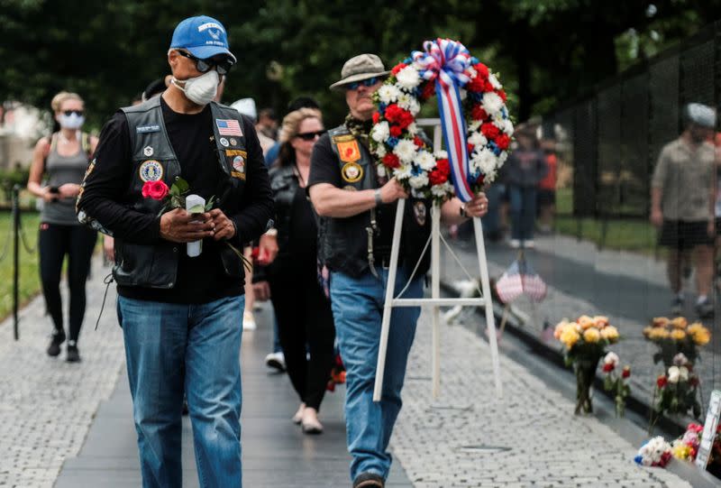 U.S. veterans carry wreath at Vietnam Veterans Memorial on Memorial Day holiday in Washington