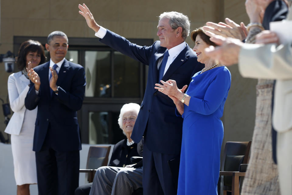 Former President George W. Bush waves after speaking at the dedication of the George W. Bush presidential library on the campus of Southern Methodist University in Dallas, Thursday, April 25, 2013. From left are, first lady Michelle Obama, President Barack Obama, and his mother, former first lady Barbara Bush, and his wife, former first lady Laura Bush. (AP Photo/Charles Dharapak)